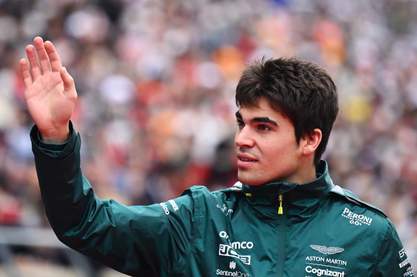 SUZUKA, JAPAN - OCTOBER 09: Lance Stroll of Canada and Aston Martin F1 Team waves to the crowd during the drivers parade ahead of the F1 Grand Prix of Japan at Suzuka International Racing Course on October 09, 2022 in Suzuka, Japan. (Photo by Clive Mason/Getty Images)