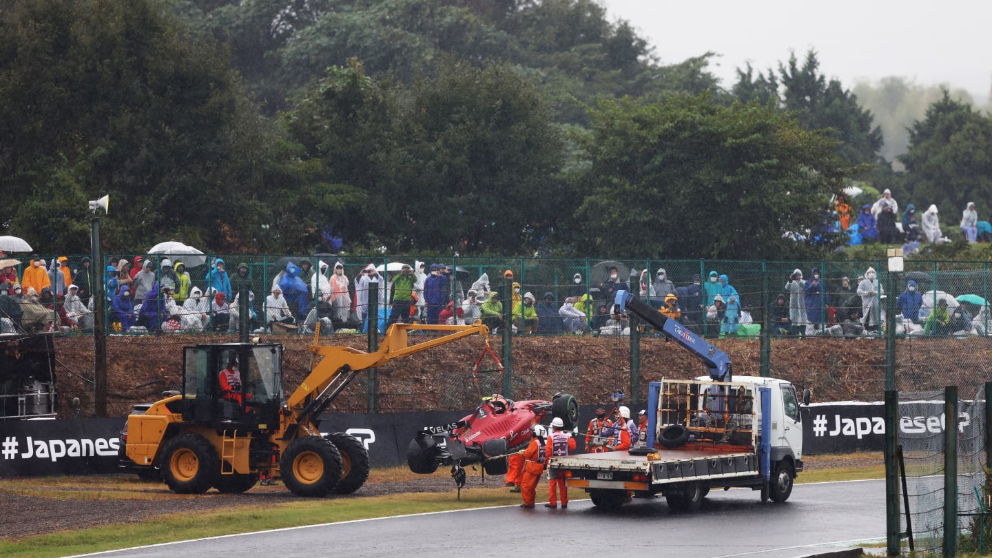 SUZUKA, JAPAN - OCTOBER 09: The car of Carlos Sainz of Spain and Ferrari is recovered from the track after a crash during the F1 Grand Prix of Japan at Suzuka International Racing Course on October 09, 2022 in Suzuka, Japan. (Photo by Bryn Lennon - Formula 1/Formula 1 via Getty Images)