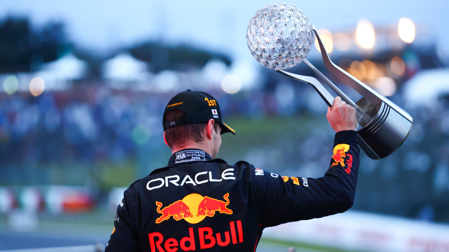 SUZUKA, JAPAN - OCTOBER 09: Race winner and 2022 F1 World Drivers Champion Max Verstappen of the Netherlands and Oracle Red Bull Racing celebrates on the podium during the F1 Grand Prix of Japan at Suzuka International Racing Course on October 09, 2022 in Suzuka, Japan. (Photo by Dan Istitene - Formula 1/Formula 1 via Getty Images)