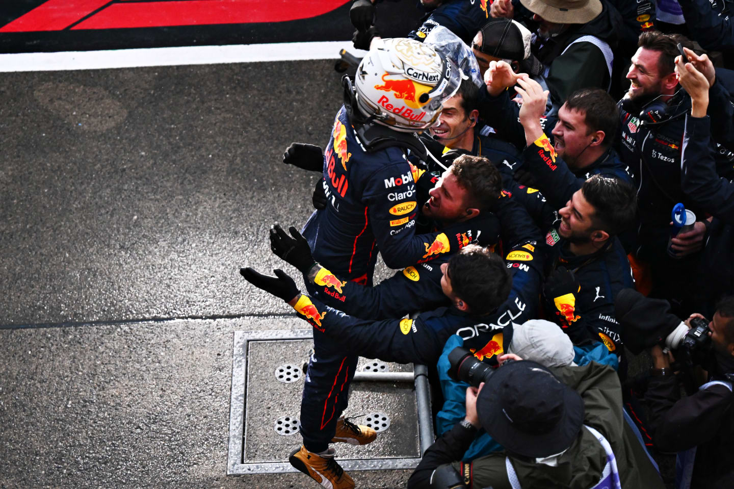 SUZUKA, JAPAN - OCTOBER 09: Race winner and 2022 F1 World Drivers Champion Max Verstappen of Netherlands and Oracle Red Bull Racing celebrates with his team in parc ferme during the F1 Grand Prix of Japan at Suzuka International Racing Course on October 09, 2022 in Suzuka, Japan. (Photo by Clive Mason/Getty Images)
