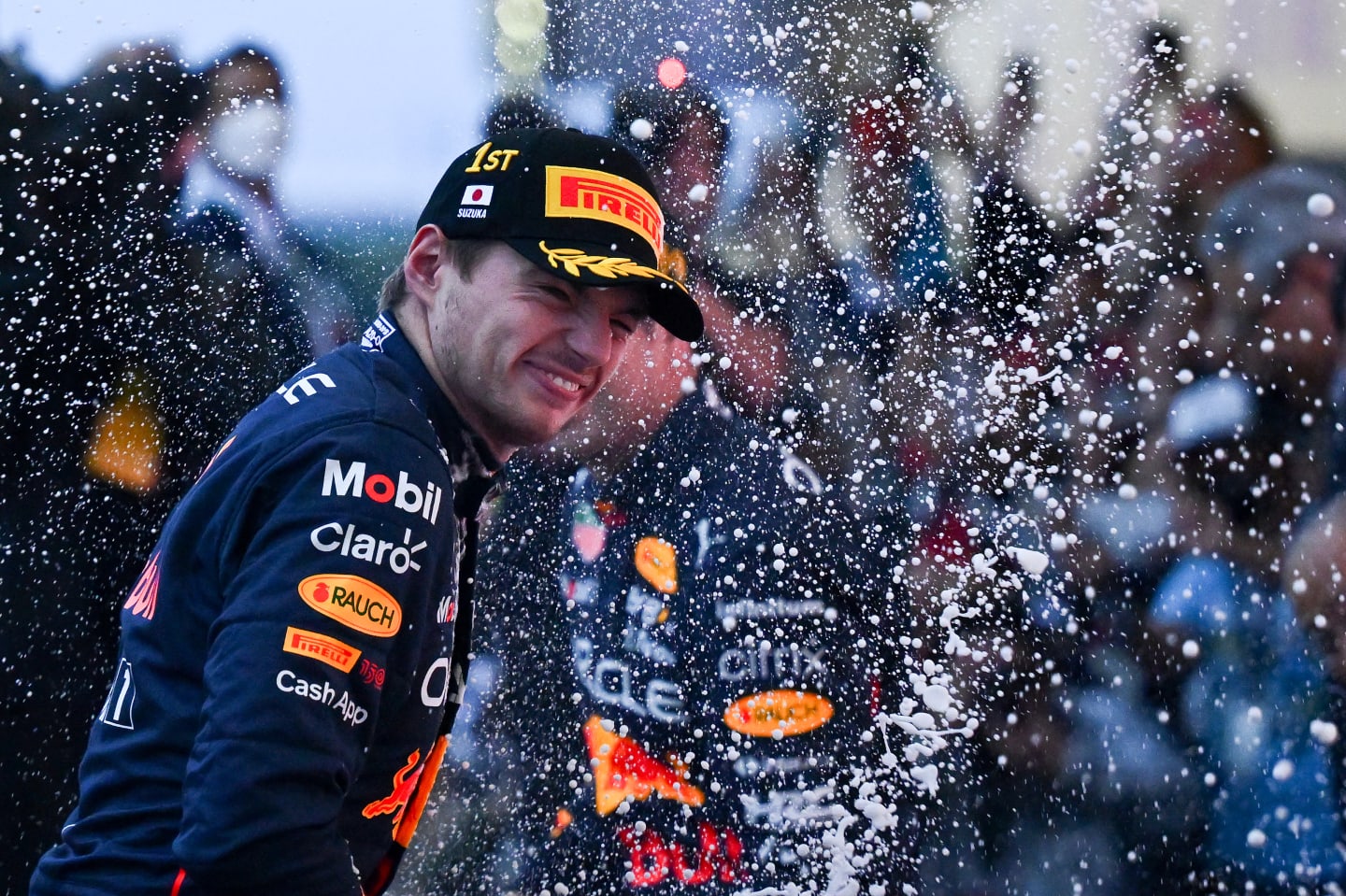 SUZUKA, JAPAN - OCTOBER 09: Race winner and 2022 F1 World Drivers Champion Max Verstappen of the Netherlands and Oracle Red Bull Racing celebrates on the podium during the F1 Grand Prix of Japan at Suzuka International Racing Course on October 09, 2022 in Suzuka, Japan. (Photo by Clive Mason/Getty Images)