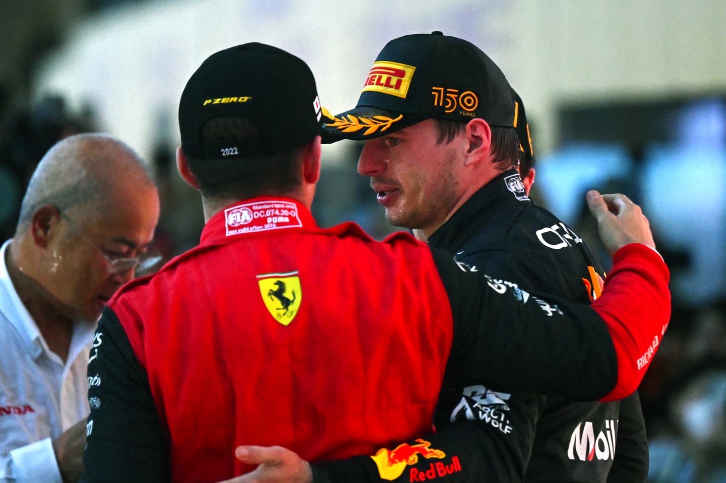SUZUKA, JAPAN - OCTOBER 09: Race winner and 2022 F1 World Drivers Champion Max Verstappen of Netherlands and Oracle Red Bull Racing and Third placed Charles Leclerc of Monaco and Ferrari celebrate on the podium during the F1 Grand Prix of Japan at Suzuka International Racing Course on October 09, 2022 in Suzuka, Japan. (Photo by Clive Mason/Getty Images)