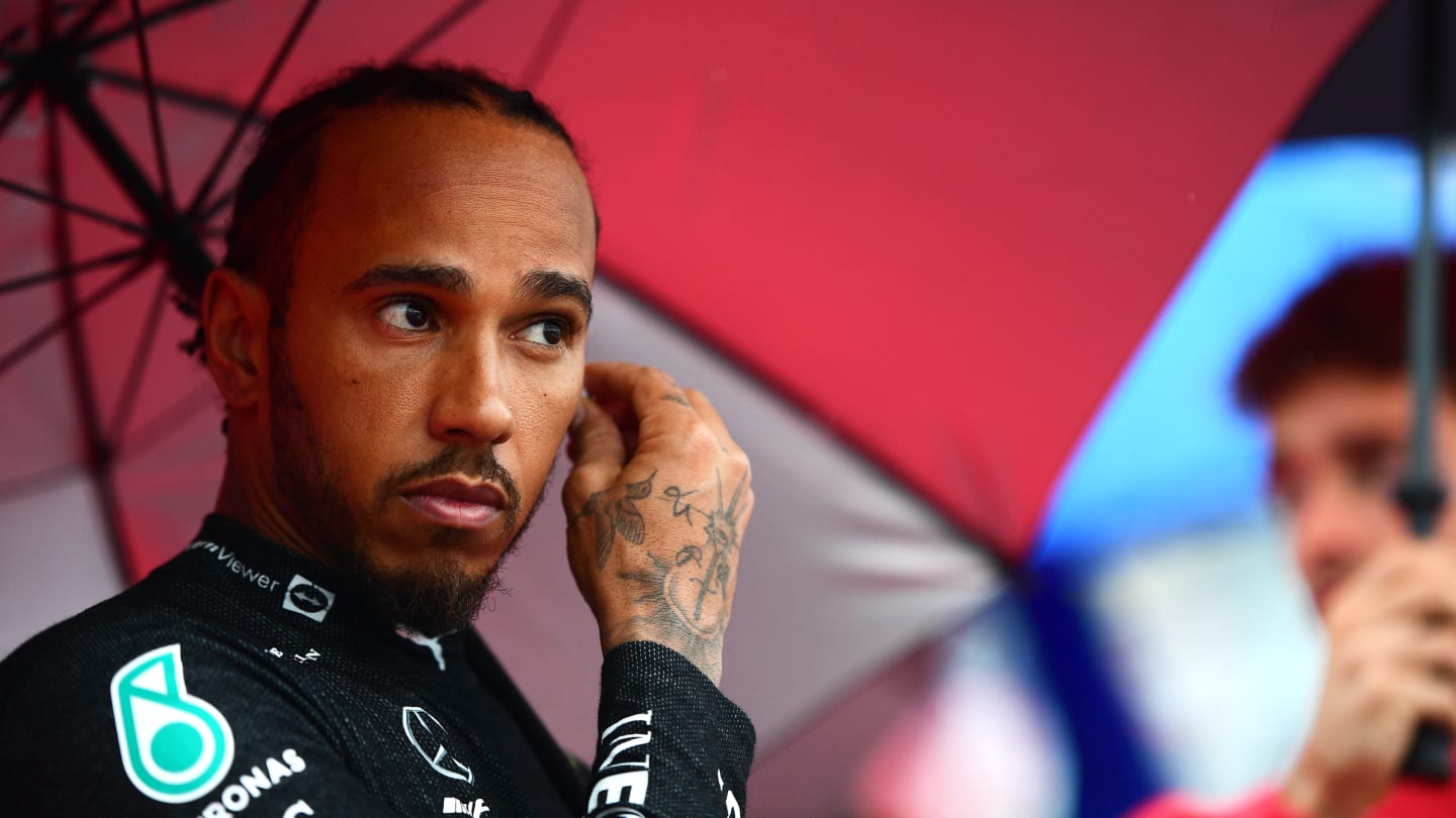 SUZUKA, JAPAN - OCTOBER 09: Lewis Hamilton of Great Britain and Mercedes looks on from the grid