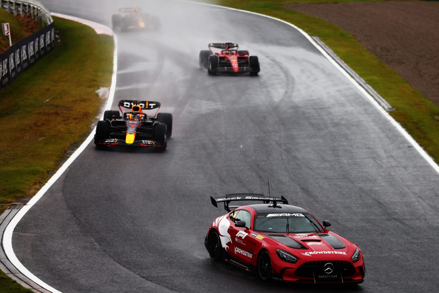 SUZUKA, JAPAN - OCTOBER 09: The FIA Safety Car leads the field at the restart after a red flag