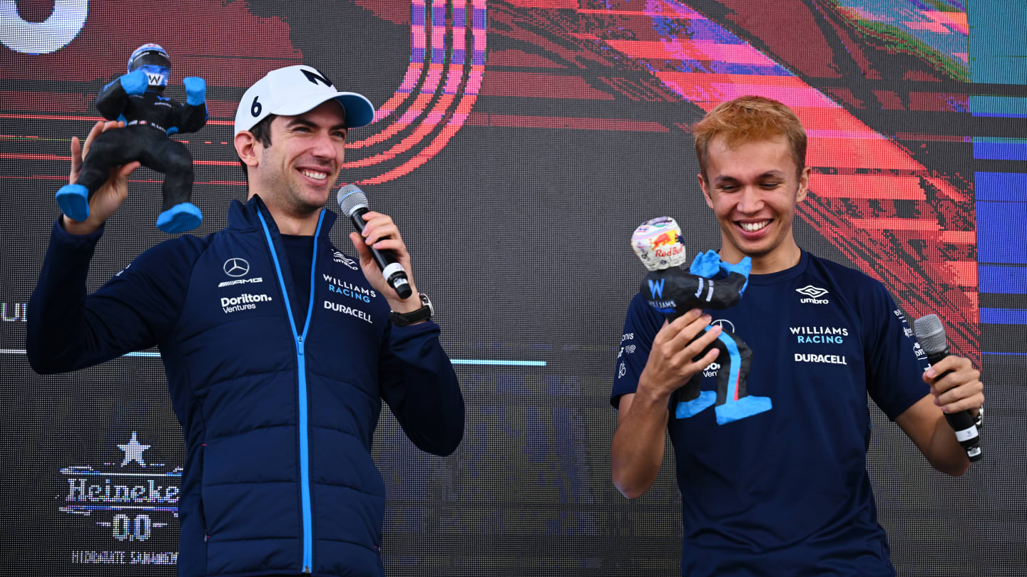 MEXICO CITY, MEXICO - OCTOBER 29: Nicholas Latifi of Canada and Williams and Alexander Albon of Thailand and Williams are presented with figurines made in their likeness on the fan stage prior to final practice ahead of the F1 Grand Prix of Mexico at Autodromo Hermanos Rodriguez on October 29, 2022 in Mexico City, Mexico. (Photo by Clive Mason - Formula 1/Formula 1 via Getty Images)