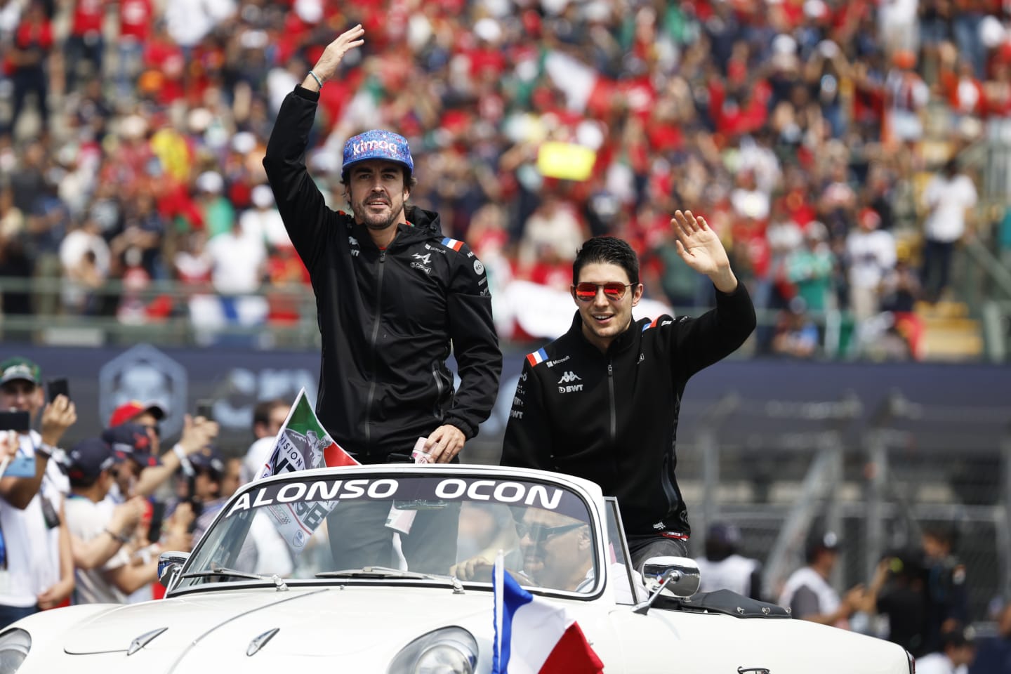MEXICO CITY, MEXICO - OCTOBER 30: Fernando Alonso of Spain and Alpine F1 and Esteban Ocon of France and Alpine F1 wave to the crowd on the drivers parade prior to the F1 Grand Prix of Mexico at Autodromo Hermanos Rodriguez on October 30, 2022 in Mexico City, Mexico. (Photo by Jared C. Tilton/Getty Images)
