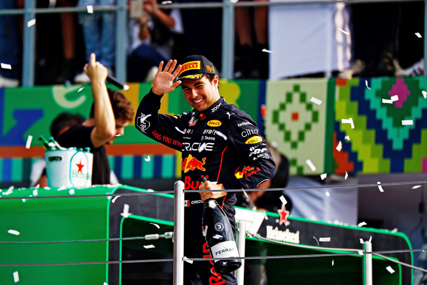 MEXICO CITY, MEXICO - OCTOBER 30: Third placed Sergio Perez of Mexico and Oracle Red Bull Racing celebrates on the podium during the F1 Grand Prix of Mexico at Autodromo Hermanos Rodriguez on October 30, 2022 in Mexico City, Mexico. (Photo by Clive Mason - Formula 1/Formula 1 via Getty Images)