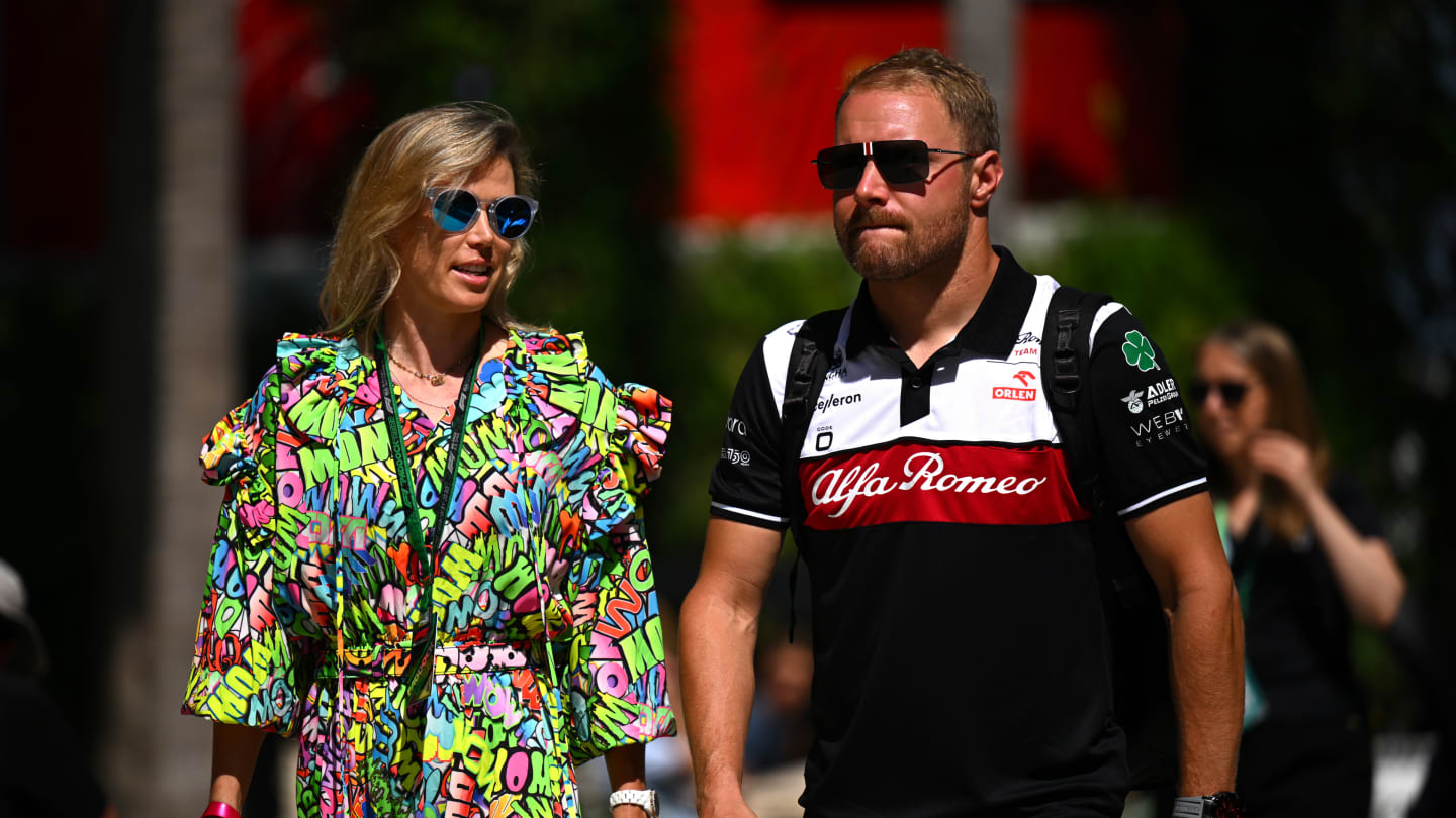 MIAMI, FLORIDA - MAY 06: Valtteri Bottas of Finland and Alfa Romeo F1 and his girlfriend cyclist Tiffany Cromwell walk in the Paddock prior to practice ahead of the F1 Grand Prix of Miami at the Miami International Autodrome on May 06, 2022 in Miami, Florida. (Photo by Clive Mason - Formula 1/Formula 1 via Getty Images)