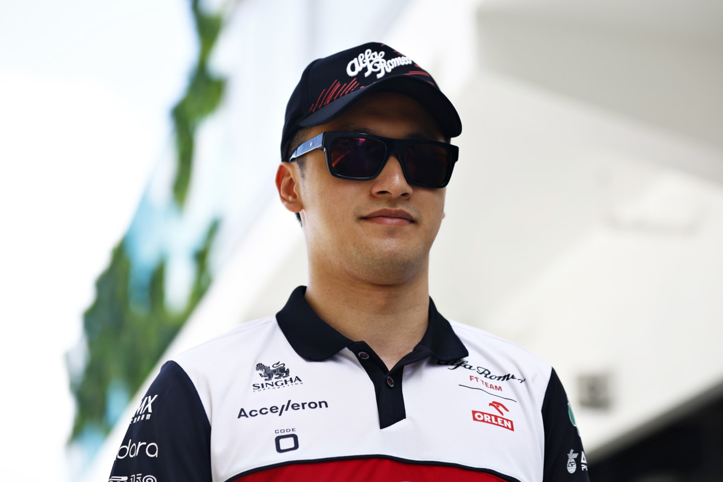 MIAMI, FLORIDA - MAY 08: Zhou Guanyu of China and Alfa Romeo F1 walks in the Paddock prior to the F1 Grand Prix of Miami at the Miami International Autodrome on May 08, 2022 in Miami, Florida. (Photo by Jared C. Tilton/Getty Images)
