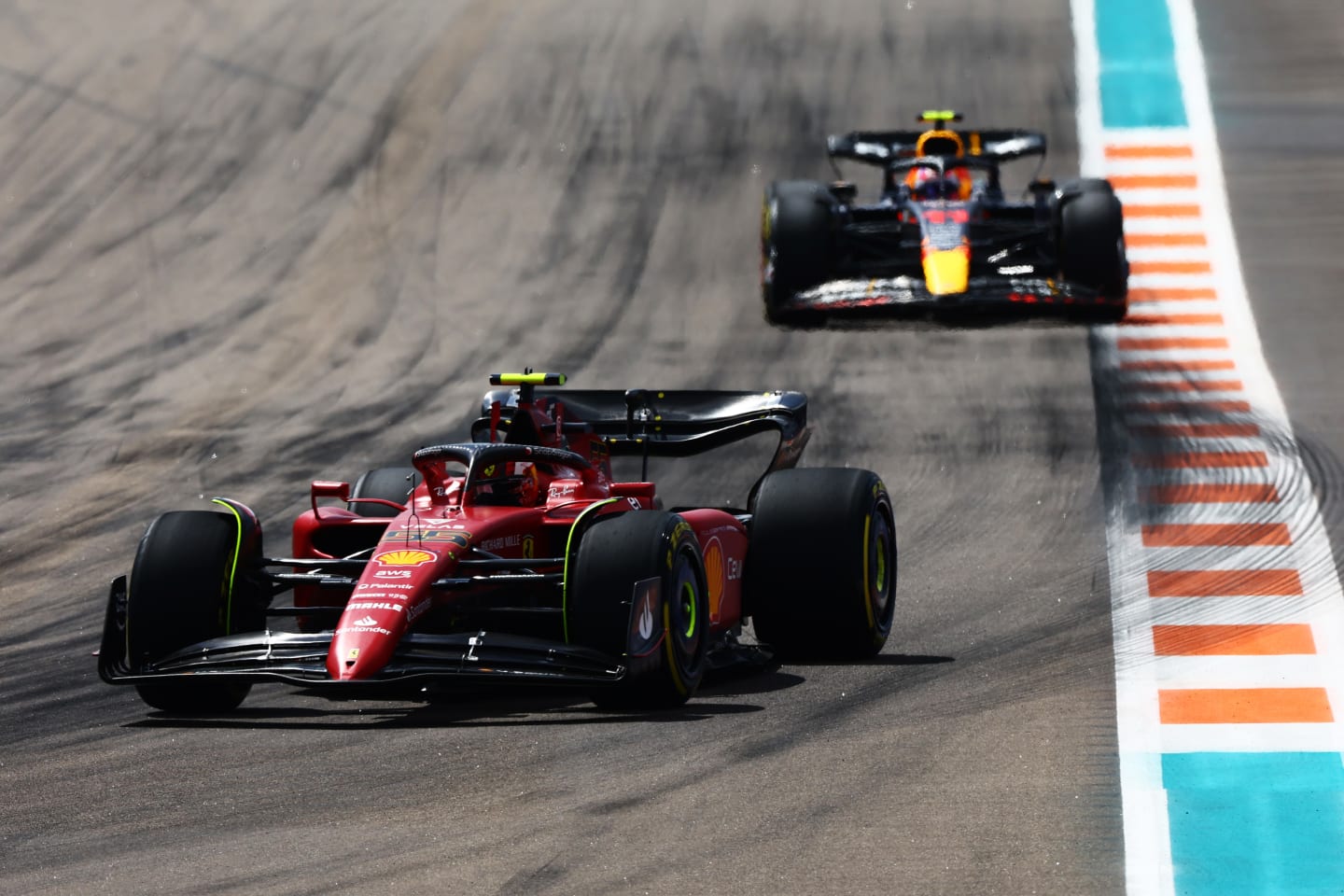 MIAMI, FLORIDA - MAY 08: Carlos Sainz of Spain driving (55) the Ferrari F1-75 leads Sergio Perez of