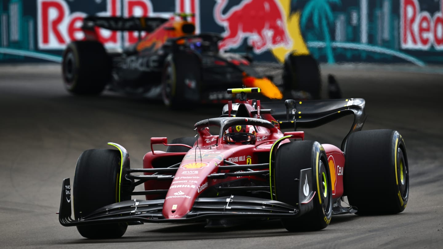 MIAMI, FLORIDA - MAY 08: Carlos Sainz of Spain driving (55) the Ferrari F1-75 leads Sergio Perez of