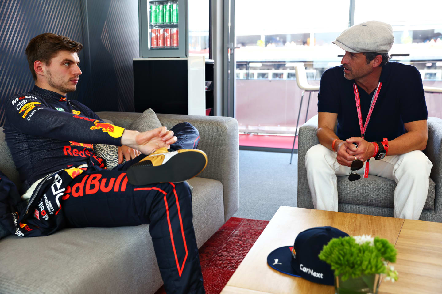 MONTE-CARLO, MONACO - MAY 28: Max Verstappen of the Netherlands and Oracle Red Bull Racing talks with Patrick Dempsey prior to qualifying ahead of the F1 Grand Prix of Monaco at Circuit de Monaco on May 28, 2022 in Monte-Carlo, Monaco. (Photo by Mark Thompson/Getty Images)