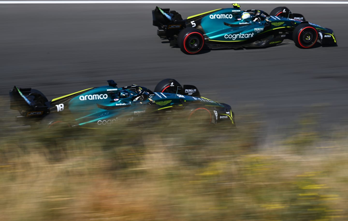 ZANDVOORT, NETHERLANDS - SEPTEMBER 03: Sebastian Vettel of Germany driving the (5) Aston Martin AMR22 Mercedes and Lance Stroll of Canada driving the (18) Aston Martin AMR22 Mercedes on track during final practice ahead of the F1 Grand Prix of The Netherlands at Circuit Zandvoort on September 03, 2022 in Zandvoort, Netherlands. (Photo by Clive Mason/Getty Images)