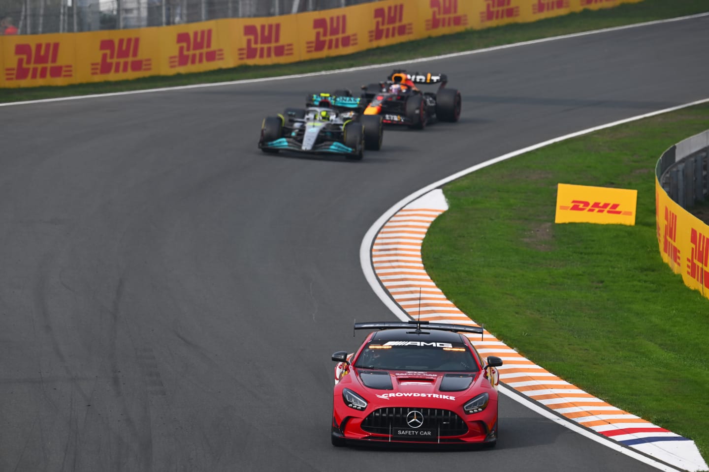 ZANDVOORT, NETHERLANDS - SEPTEMBER 04: The FIA safety car leads Lewis Hamilton of Great Britain driving the (44) Mercedes AMG Petronas F1 Team W13 and Max Verstappen of the Netherlands driving the (1) Oracle Red Bull Racing RB18 during the F1 Grand Prix of The Netherlands at Circuit Zandvoort on September 04, 2022 in Zandvoort, Netherlands. (Photo by Clive Mason/Getty Images)