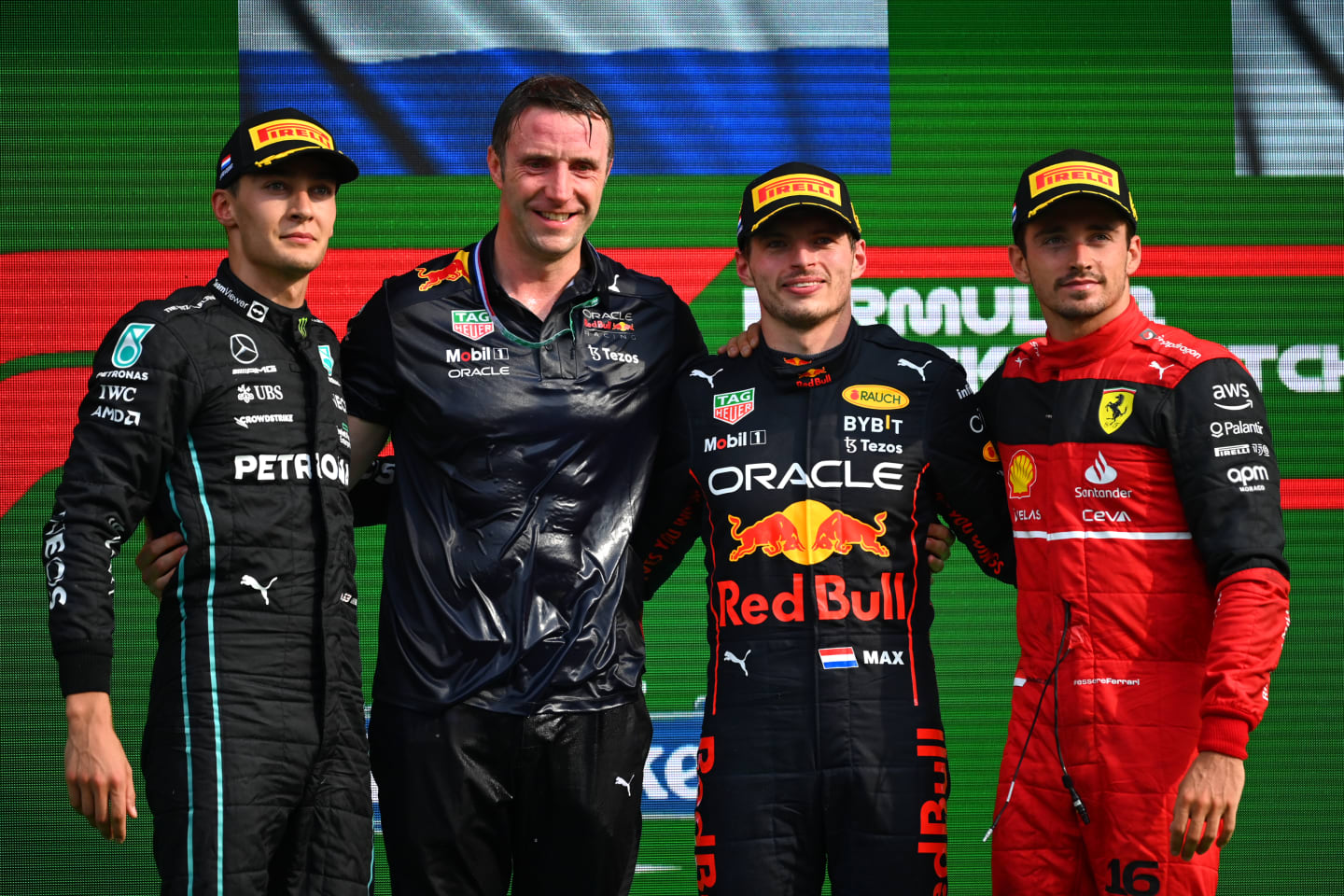 ZANDVOORT, NETHERLANDS - SEPTEMBER 04: Race winner Max Verstappen of the Netherlands and Oracle Red Bull Racing, second placed George Russell of Great Britain and Mercedes and third placed Charles Leclerc of Monaco and Ferrari celebrate on the podium during the F1 Grand Prix of The Netherlands at Circuit Zandvoort on September 04, 2022 in Zandvoort, Netherlands. (Photo by Dan Mullan/Getty Images)