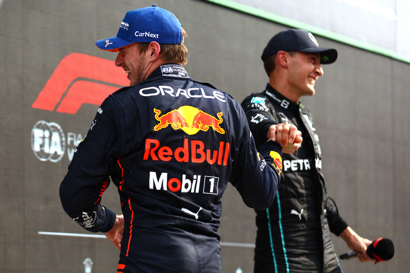 ZANDVOORT, NETHERLANDS - SEPTEMBER 04: Race winner Max Verstappen of the Netherlands and Oracle Red Bull Racing celebrates with second placed George Russell of Great Britain and Mercedes in parc ferme during the F1 Grand Prix of The Netherlands at Circuit Zandvoort on September 04, 2022 in Zandvoort, Netherlands. (Photo by Mark Thompson/Getty Images)