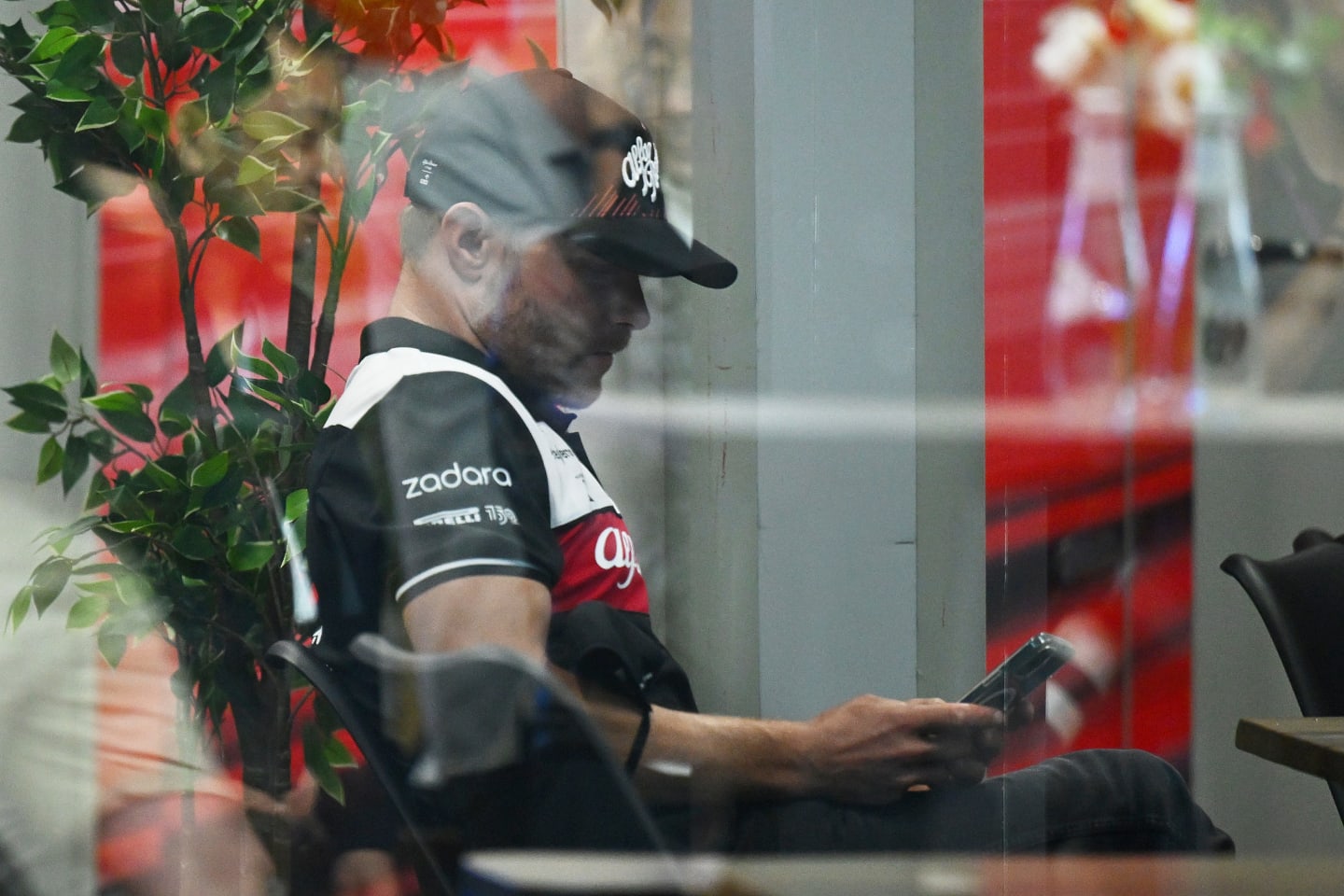 JEDDAH, SAUDI ARABIA - MARCH 25: Valtteri Bottas of Finland and Alfa Romeo F1 looks at his phone
