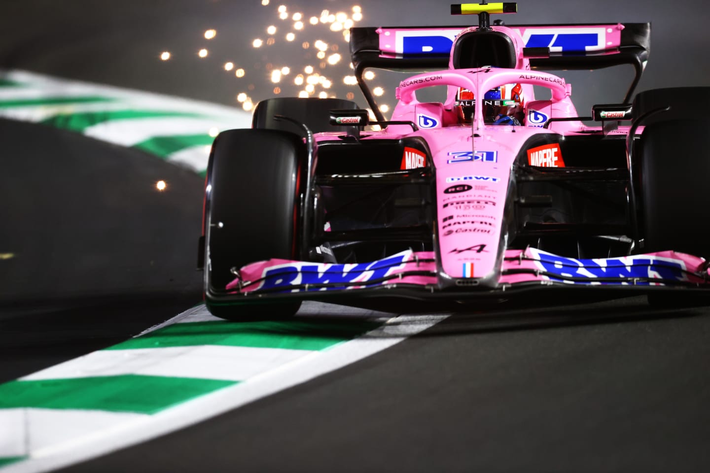 JEDDAH, SAUDI ARABIA - MARCH 26: Sparks fly behind Esteban Ocon of France driving the (31) Alpine F1 A522 Renault during qualifying ahead of the F1 Grand Prix of Saudi Arabia at the Jeddah Corniche Circuit on March 26, 2022 in Jeddah, Saudi Arabia. (Photo by Dan Istitene - Formula 1/Formula 1 via Getty Images)