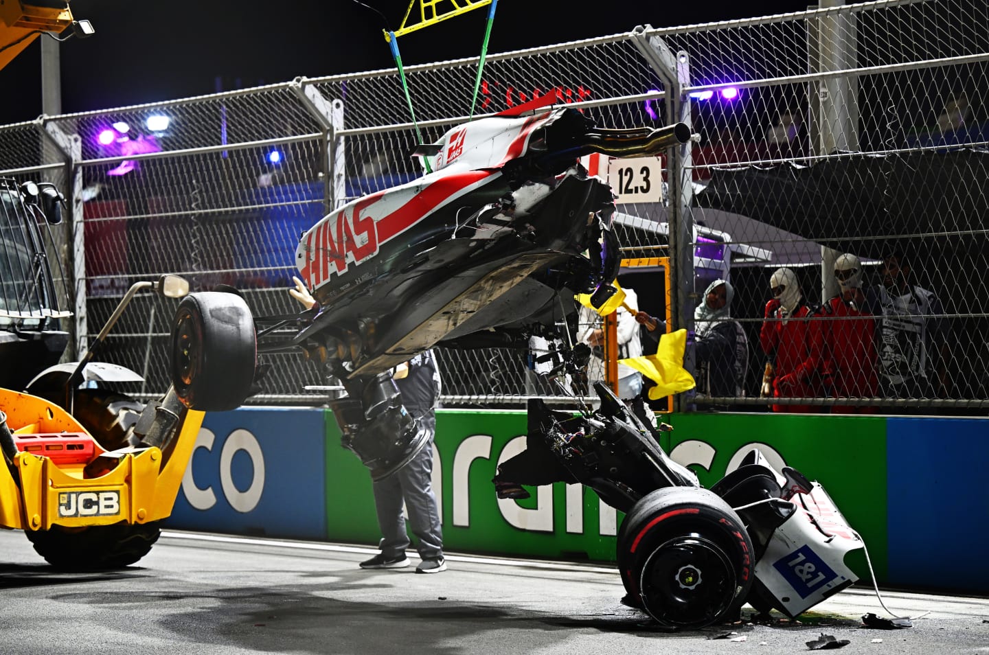 JEDDAH, SAUDI ARABIA - MARCH 26: Track marshals clean debris from the track following the crash of Mick Schumacher of Germany and Haas F1 during qualifying ahead of the F1 Grand Prix of Saudi Arabia at the Jeddah Corniche Circuit on March 26, 2022 in Jeddah, Saudi Arabia. (Photo by Clive Mason/Getty Images)