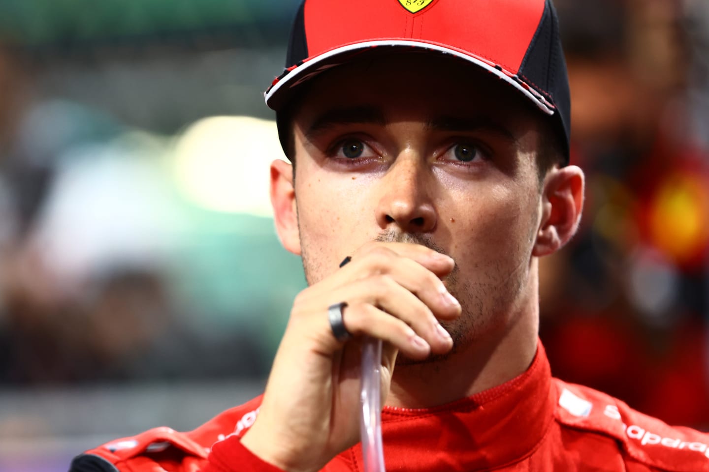 JEDDAH, SAUDI ARABIA - MARCH 26: Second placed qualifier Charles Leclerc of Monaco and Ferrari takes a drink in parc ferme during qualifying ahead of the F1 Grand Prix of Saudi Arabia at the Jeddah Corniche Circuit on March 26, 2022 in Jeddah, Saudi Arabia. (Photo by Mark Thompson/Getty Images)