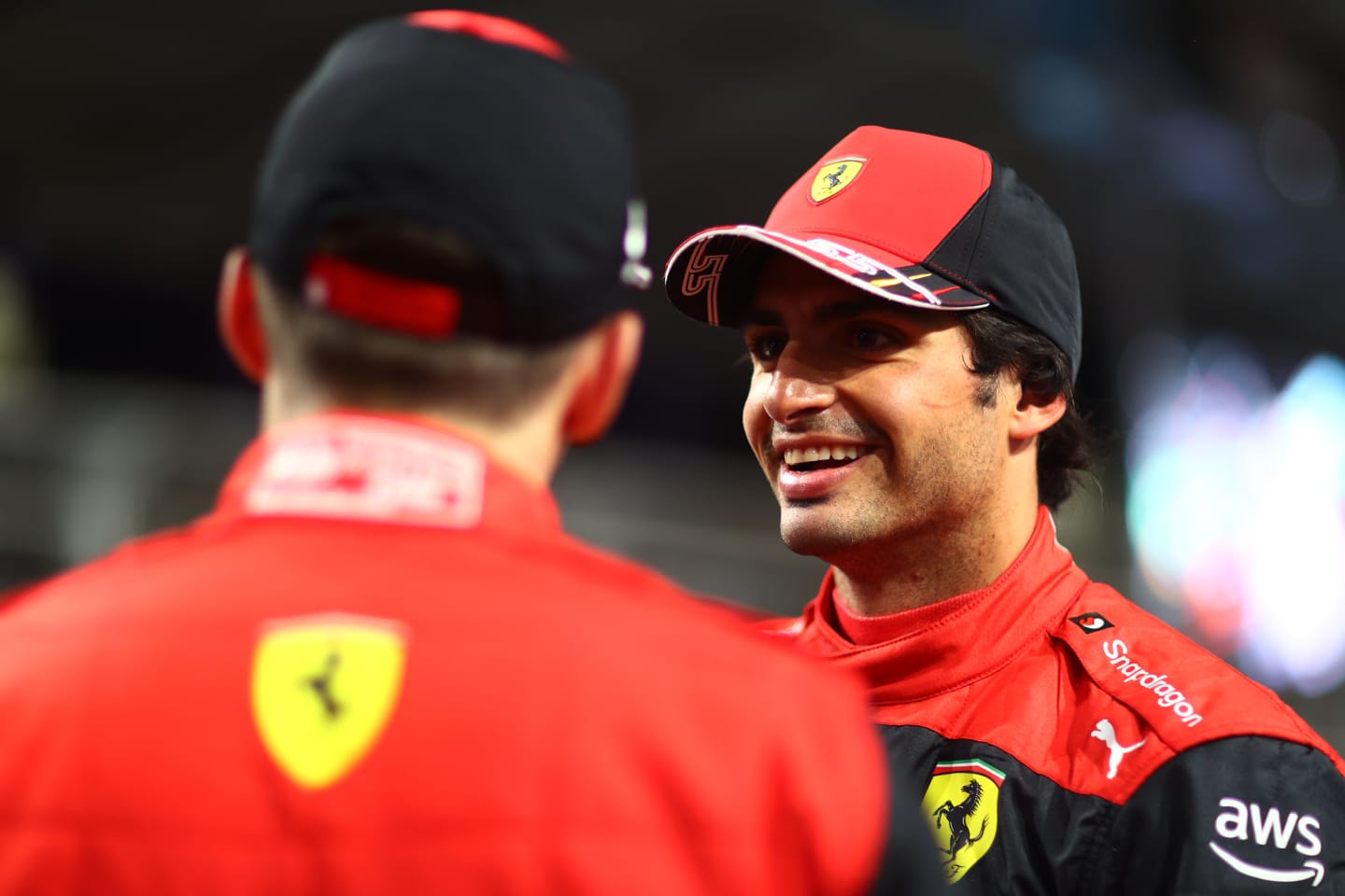 JEDDAH, SAUDI ARABIA - MARCH 26: Third placed qualifier Carlos Sainz of Spain and Ferrari talks with Second placed qualifier Charles Leclerc of Monaco and Ferrari in parc ferme during qualifying ahead of the F1 Grand Prix of Saudi Arabia at the Jeddah Corniche Circuit on March 26, 2022 in Jeddah, Saudi Arabia. (Photo by Dan Istitene - Formula 1/Formula 1 via Getty Images)