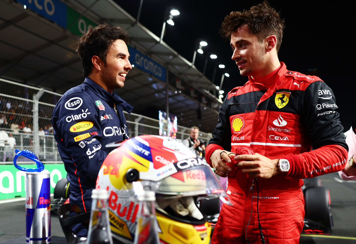 JEDDAH, SAUDI ARABIA - MARCH 26: Second placed qualifier Charles Leclerc of Monaco and Ferrari (R) talks to Pole position qualifier Sergio Perez of Mexico and Oracle Red Bull Racing (L) in parc ferme during qualifying ahead of the F1 Grand Prix of Saudi Arabia at the Jeddah Corniche Circuit on March 26, 2022 in Jeddah, Saudi Arabia. (Photo by Mark Thompson/Getty Images)
