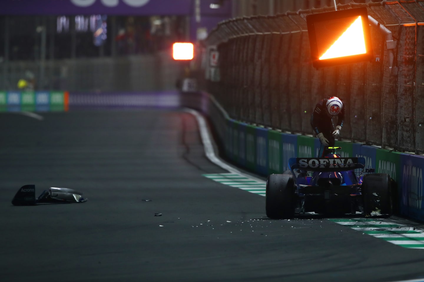 JEDDAH, SAUDI ARABIA - MARCH 27: Nicholas Latifi of Canada driving the (6) Williams FW44 Mercedes climbs from his car after crashing during the F1 Grand Prix of Saudi Arabia at the Jeddah Corniche Circuit on March 27, 2022 in Jeddah, Saudi Arabia. (Photo by Joe Portlock - Formula 1/Formula 1 via Getty Images)