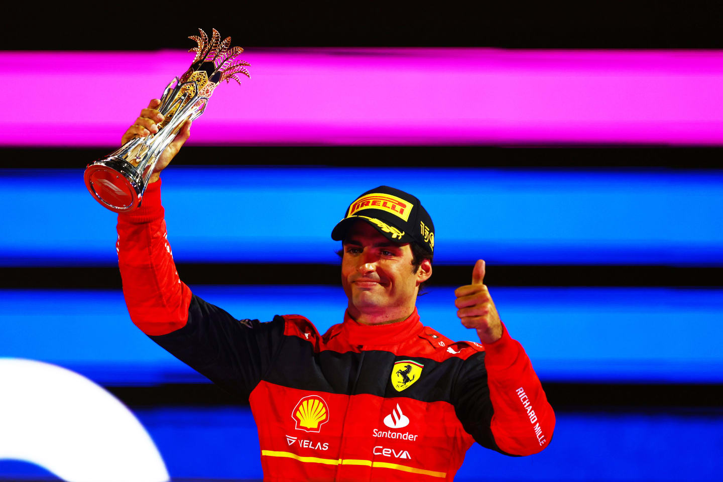 JEDDAH, SAUDI ARABIA - MARCH 27: Third placed Carlos Sainz of Spain and Ferrari celebrates on the podium during the F1 Grand Prix of Saudi Arabia at the Jeddah Corniche Circuit on March 27, 2022 in Jeddah, Saudi Arabia. (Photo by Mark Thompson/Getty Images)