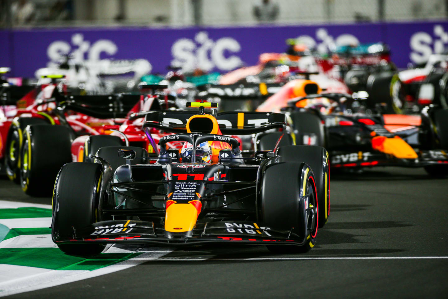 JEDDAH, SAUDI ARABIA - MARCH 27: Sergio Perez of Mexico and Red Bull Racing leads into the first corner during the F1 Grand Prix of Saudi Arabia at the Jeddah Corniche Circuit on March 27, 2022 in Jeddah, Saudi Arabia. (Photo by Peter Fox/Getty Images)