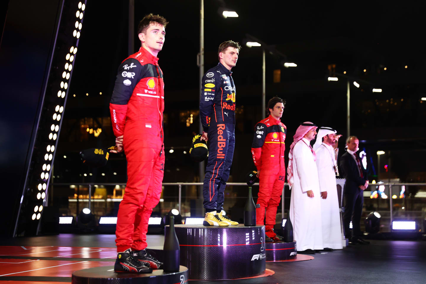 JEDDAH, SAUDI ARABIA - MARCH 27: Race winner Max Verstappen of the Netherlands and Oracle Red Bull Racing, Second placed Charles Leclerc of Monaco and Ferrari and Third placed Carlos Sainz of Spain and Ferrari stand on the podium during the F1 Grand Prix of Saudi Arabia at the Jeddah Corniche Circuit on March 27, 2022 in Jeddah, Saudi Arabia. (Photo by Dan Istitene - Formula 1/Formula 1 via Getty Images)