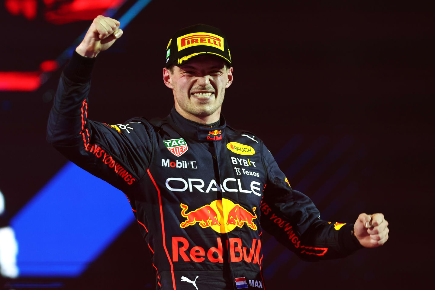 JEDDAH, SAUDI ARABIA - MARCH 27: Race winner Max Verstappen of the Netherlands and Oracle Red Bull Racing celebrates on the podium during the F1 Grand Prix of Saudi Arabia at the Jeddah Corniche Circuit on March 27, 2022 in Jeddah, Saudi Arabia. (Photo by Lars Baron/Getty Images)