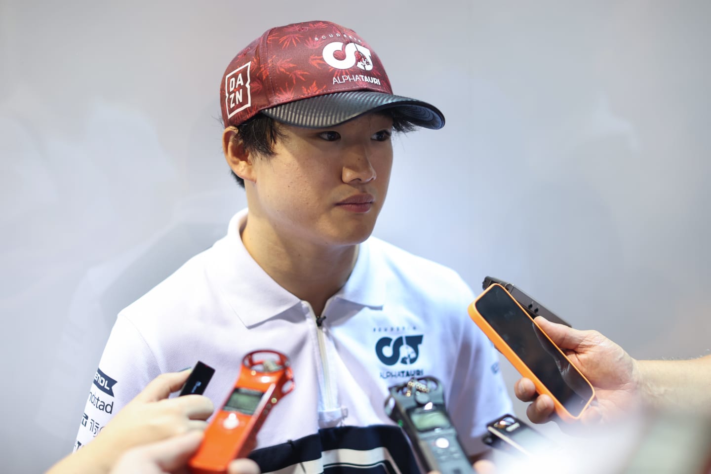 SINGAPORE, SINGAPORE - SEPTEMBER 30: Yuki Tsunoda of Japan and Scuderia AlphaTauri talks to the media in the Paddock after practice ahead of the F1 Grand Prix of Singapore at Marina Bay Street Circuit on September 30, 2022 in Singapore, Singapore. (Photo by Peter Fox/Getty Images,)