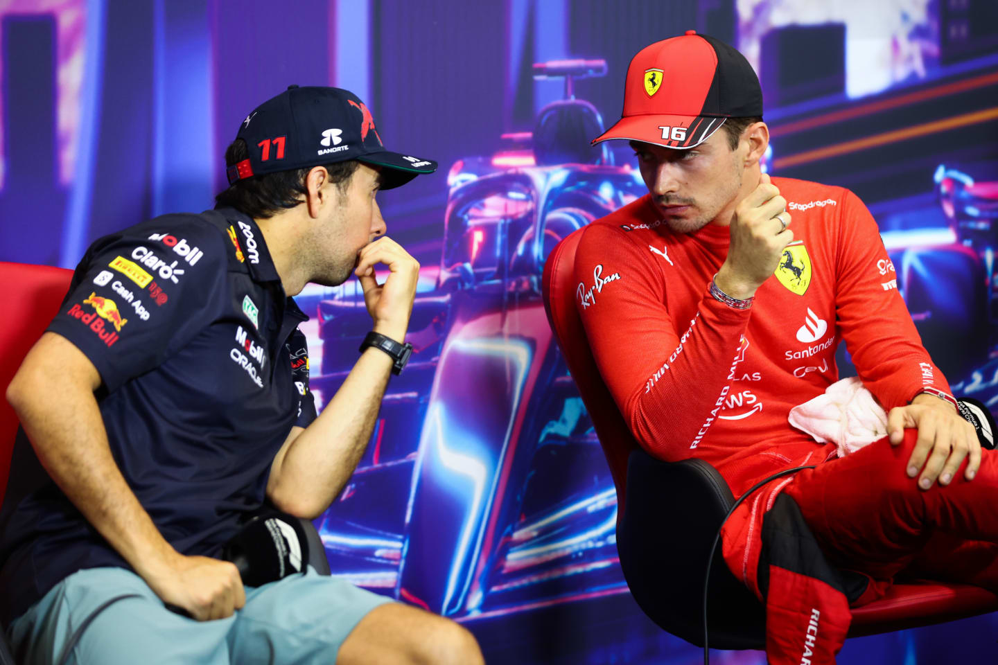 SINGAPORE, SINGAPORE - OCTOBER 01: Pole position qualifier Charles Leclerc of Monaco and Ferrari and Second placed qualifier Sergio Perez of Mexico and Oracle Red Bull Racing talk in the press conference after qualifying ahead of the F1 Grand Prix of Singapore at Marina Bay Street Circuit on October 01, 2022 in Singapore, Singapore. (Photo by Dan Istitene/Getty Images)