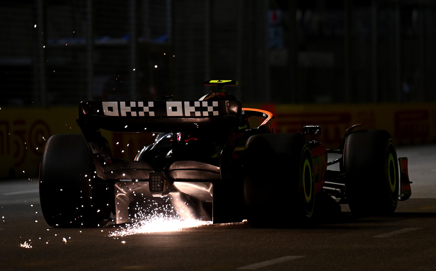 SINGAPORE, SINGAPORE - OCTOBER 01: Sparks fly from the car of Lando Norris of Great Britain driving