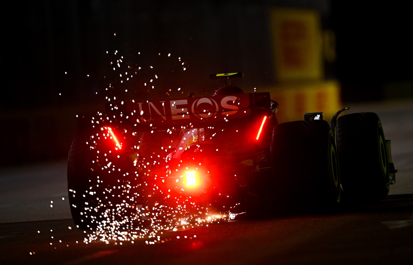 SINGAPORE, SINGAPORE - OCTOBER 01: Sparks fly from the car of Lewis Hamilton of Great Britain