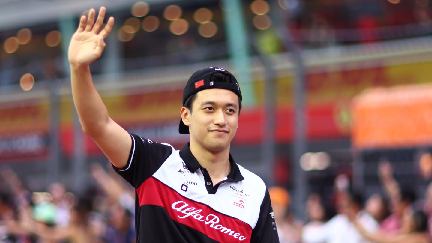 SINGAPORE, SINGAPORE - OCTOBER 02: Zhou Guanyu of China and Alfa Romeo F1 waves to the crowd on the drivers parade prior to  the F1 Grand Prix of Singapore at Marina Bay Street Circuit on October 02, 2022 in Singapore, Singapore. (Photo by Dan Istitene - Formula 1/Formula 1 via Getty Images)