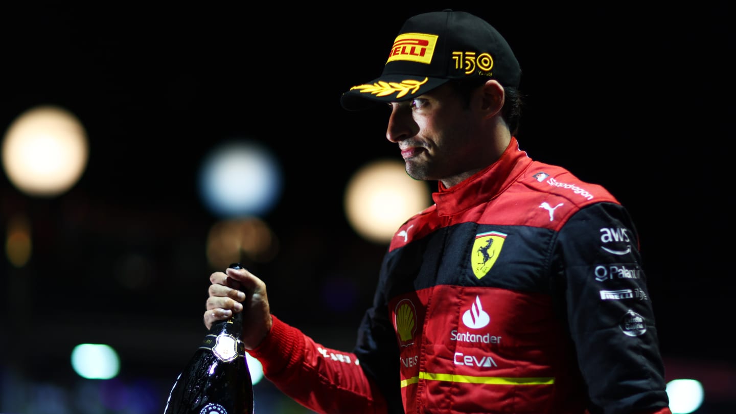 SINGAPORE, SINGAPORE - OCTOBER 02: Third placed Carlos Sainz of Spain and Ferrari celebrates on the podium during the F1 Grand Prix of Singapore at Marina Bay Street Circuit on October 02, 2022 in Singapore, Singapore. (Photo by Dan Istitene - Formula 1/Formula 1 via Getty Images)