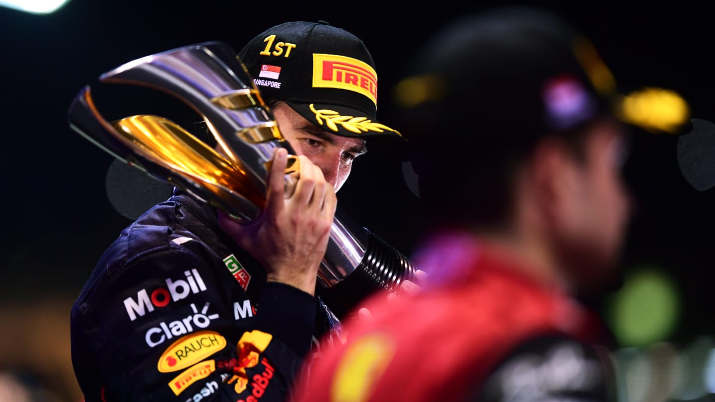 SINGAPORE, SINGAPORE - OCTOBER 02: Race winner Sergio Perez of Mexico and Oracle Red Bull Racing celebrates on the podium during the F1 Grand Prix of Singapore at Marina Bay Street Circuit on October 02, 2022 in Singapore, Singapore. (Photo by Mario Renzi - Formula 1/Formula 1 via Getty Images)