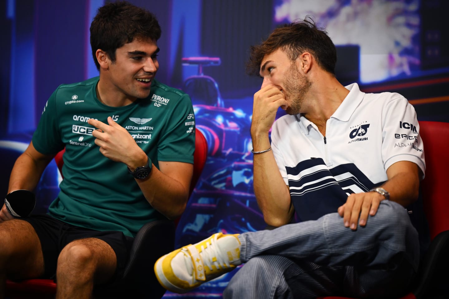 SINGAPORE, SINGAPORE - SEPTEMBER 29: Pierre Gasly of France and Scuderia AlphaTauri and Lance Stroll of Canada and Aston Martin F1 Team talk in the Drivers Press Conference during previews ahead of the F1 Grand Prix of Singapore at Marina Bay Street Circuit on September 29, 2022 in Singapore, Singapore. (Photo by Clive Mason/Getty Images,)