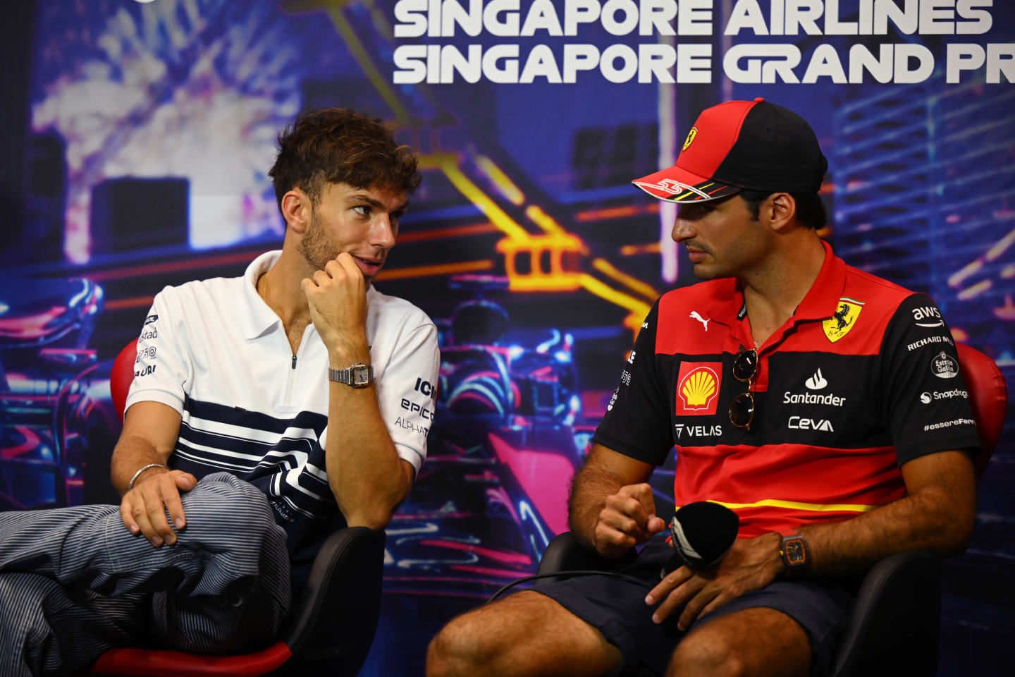 SINGAPORE, SINGAPORE - SEPTEMBER 29: Pierre Gasly of France and Scuderia AlphaTauri and Carlos Sainz of Spain and Ferrari talk in the Drivers Press Conference during previews ahead of the F1 Grand Prix of Singapore at Marina Bay Street Circuit on September 29, 2022 in Singapore, Singapore. (Photo by Clive Mason/Getty Images,)