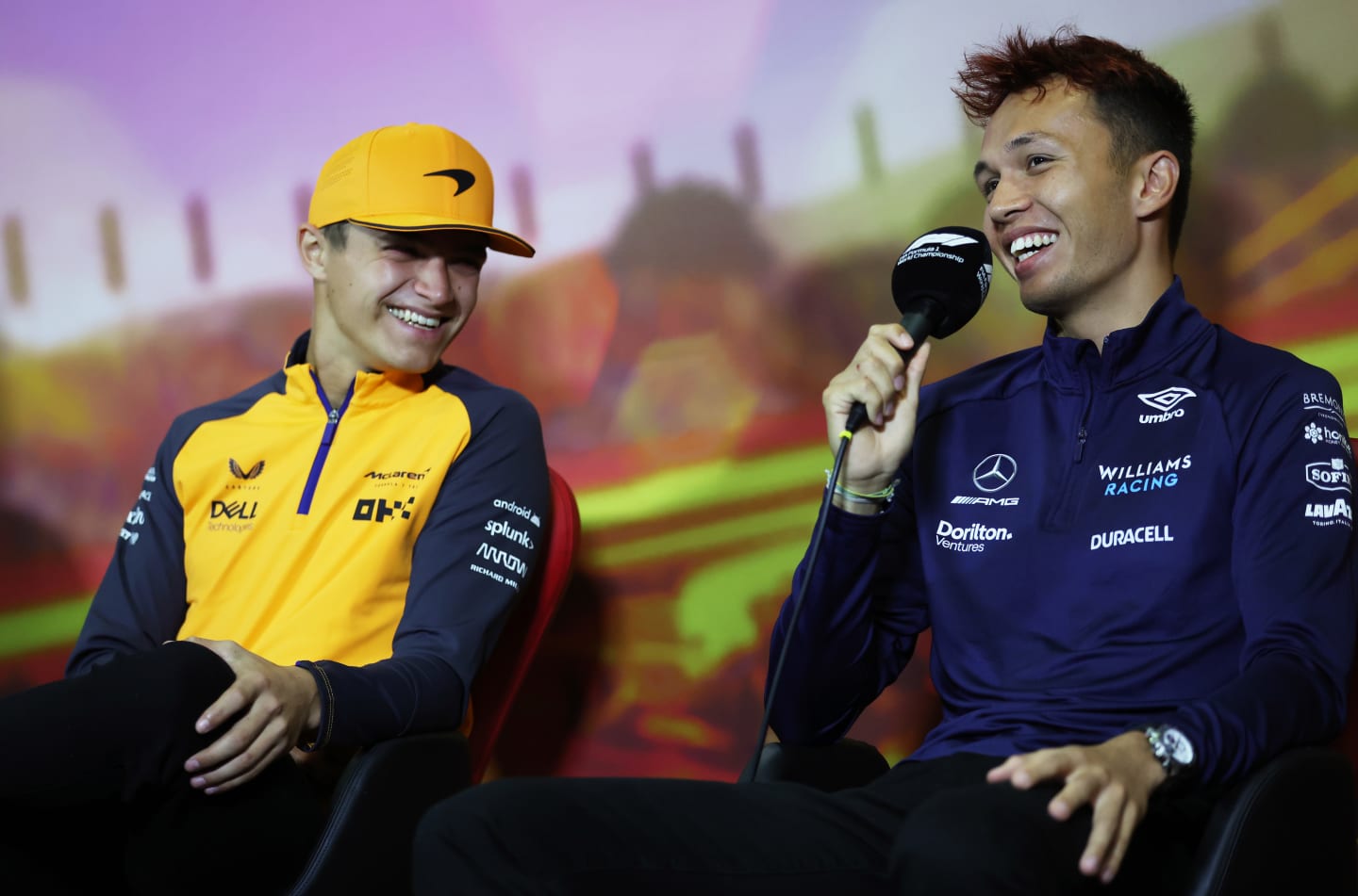 BARCELONA, SPAIN - MAY 20: Alexander Albon of Thailand and Williams and Lando Norris of Great Britain and McLaren laugh in the Drivers Press Conference prior to practice ahead of the F1 Grand Prix of Spain at Circuit de Barcelona-Catalunya on May 20, 2022 in Barcelona, Spain. (Photo by Bryn Lennon/Getty Images)