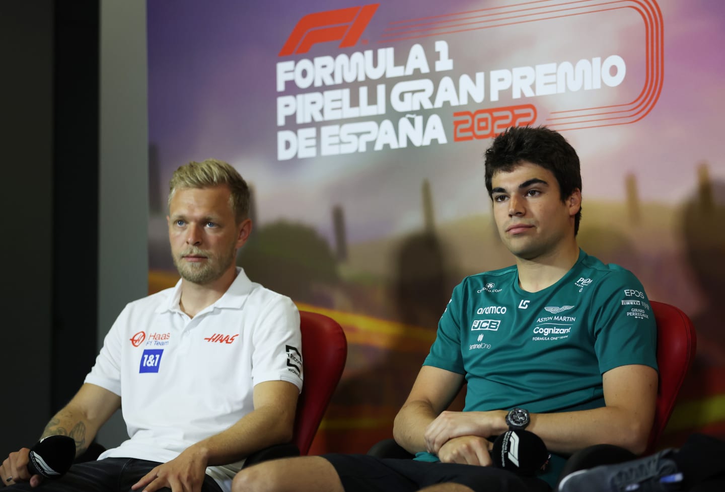 BARCELONA, SPAIN - MAY 20: Lance Stroll of Canada and Aston Martin F1 Team looks on in the Drivers Press Conference next to Kevin Magnussen of Denmark and Haas F1 prior to practice ahead of the F1 Grand Prix of Spain at Circuit de Barcelona-Catalunya on May 20, 2022 in Barcelona, Spain. (Photo by Bryn Lennon/Getty Images)