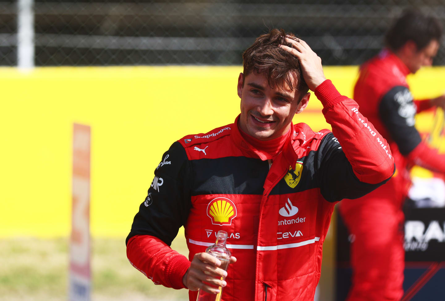 BARCELONA, SPAIN - MAY 21: Pole position qualifier Charles Leclerc of Monaco and Ferrari smiles in parc ferme during qualifying ahead of the F1 Grand Prix of Spain at Circuit de Barcelona-Catalunya on May 21, 2022 in Barcelona, Spain. (Photo by Mark Thompson/Getty Images)
