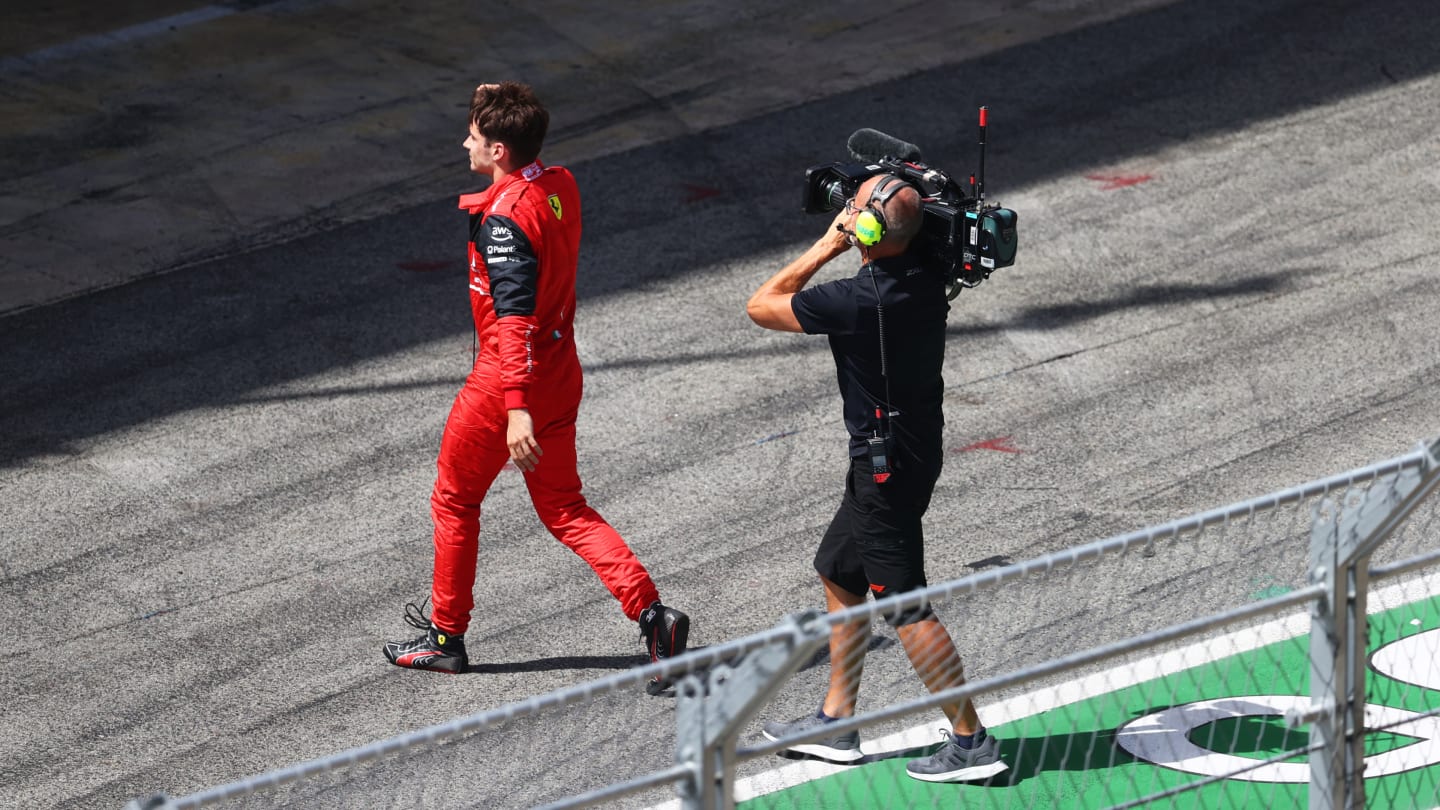 BARCELONA, SPAIN - MAY 22: Charles Leclerc of Monaco and Ferrari walks in the Pitlane after retiring from the race during the F1 Grand Prix of Spain at Circuit de Barcelona-Catalunya on May 22, 2022 in Barcelona, Spain. (Photo by Dan Istitene - Formula 1/Formula 1 via Getty Images)