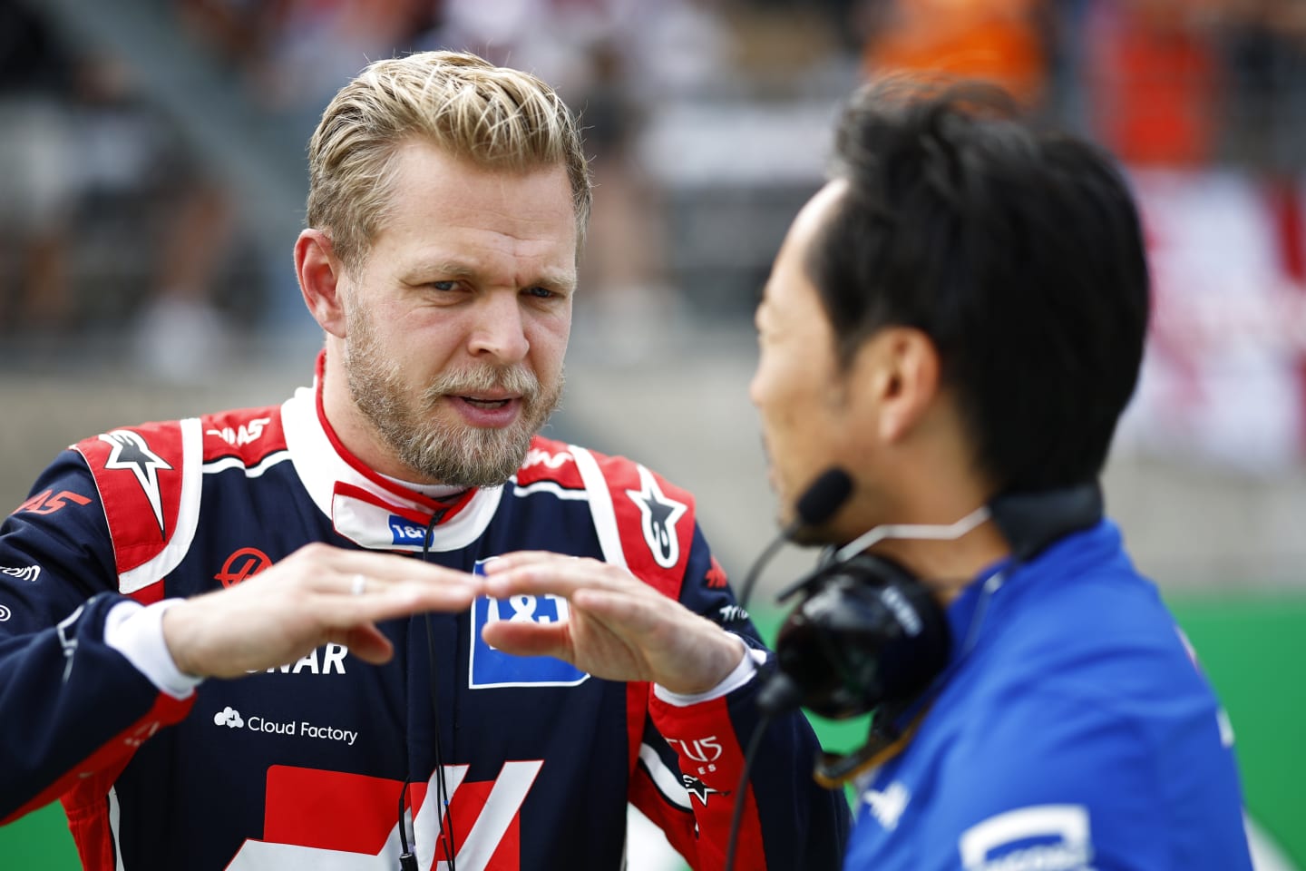 AUSTIN, TEXAS - OCTOBER 23: Kevin Magnussen of Denmark and Haas F1 talks with Ayao Komatsu on the grid during the F1 Grand Prix of USA at Circuit of The Americas on October 23, 2022 in Austin, Texas. (Photo by Chris Graythen/Getty Images)