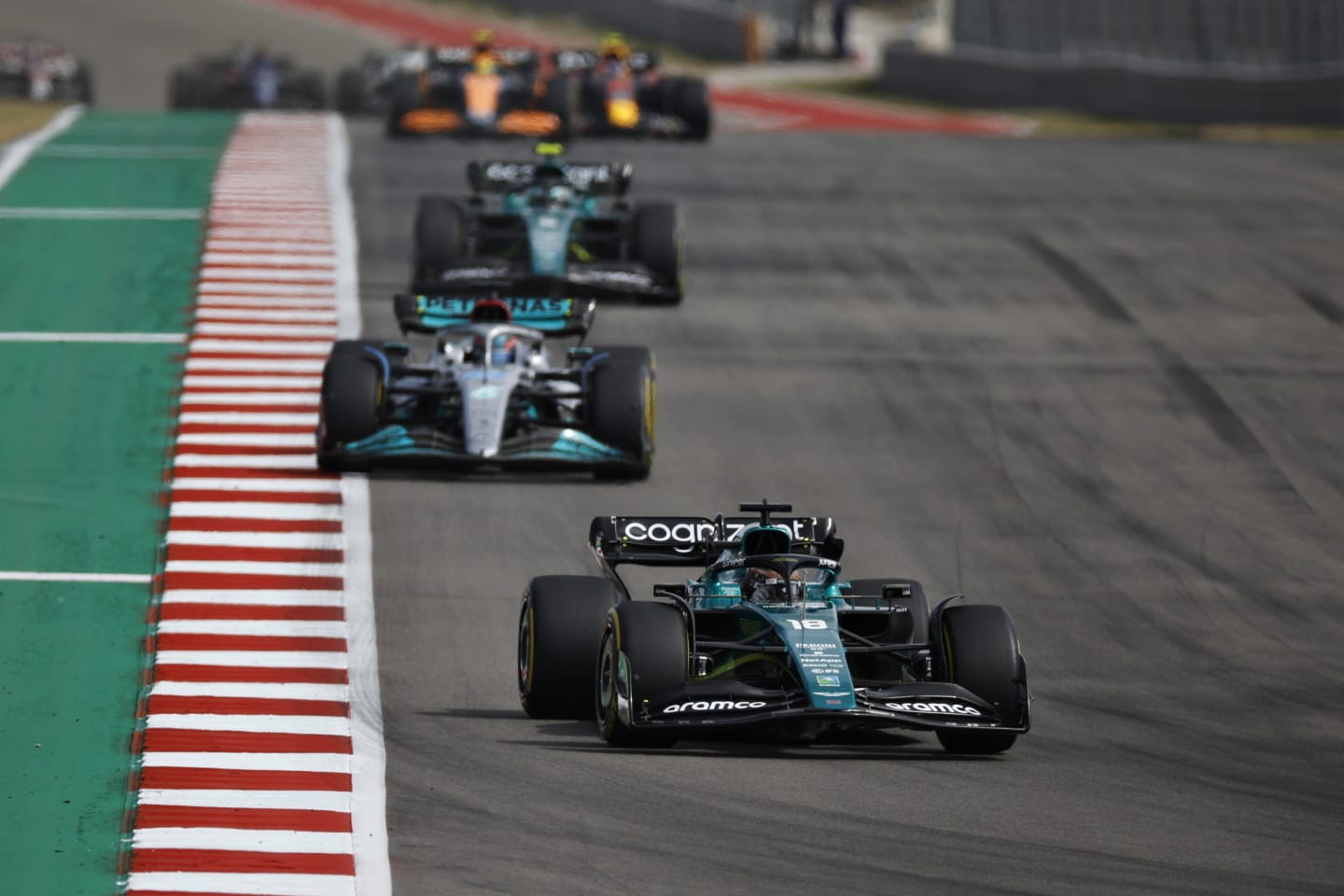 AUSTIN, TEXAS - OCTOBER 23: Lance Stroll of Canada driving the (18) Aston Martin AMR22 Mercedes leads George Russell of Great Britain driving the (63) Mercedes AMG Petronas F1 Team W13 on track during the F1 Grand Prix of USA at Circuit of The Americas on October 23, 2022 in Austin, Texas. (Photo by Jared C. Tilton/Getty Images)