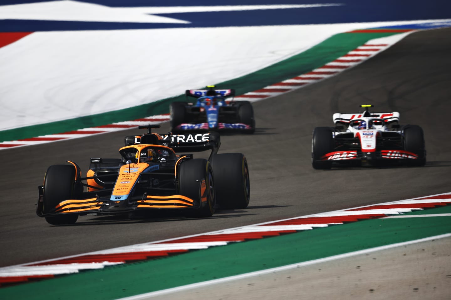 AUSTIN, TEXAS - OCTOBER 23: Daniel Ricciardo of Australia driving the (3) McLaren MCL36 Mercedes leads Mick Schumacher of Germany driving the (47) Haas F1 VF-22 Ferrari and Esteban Ocon of France driving the (31) Alpine F1 A522 Renault on track during the F1 Grand Prix of USA at Circuit of The Americas on October 23, 2022 in Austin, Texas. (Photo by Chris Graythen/Getty Images)
