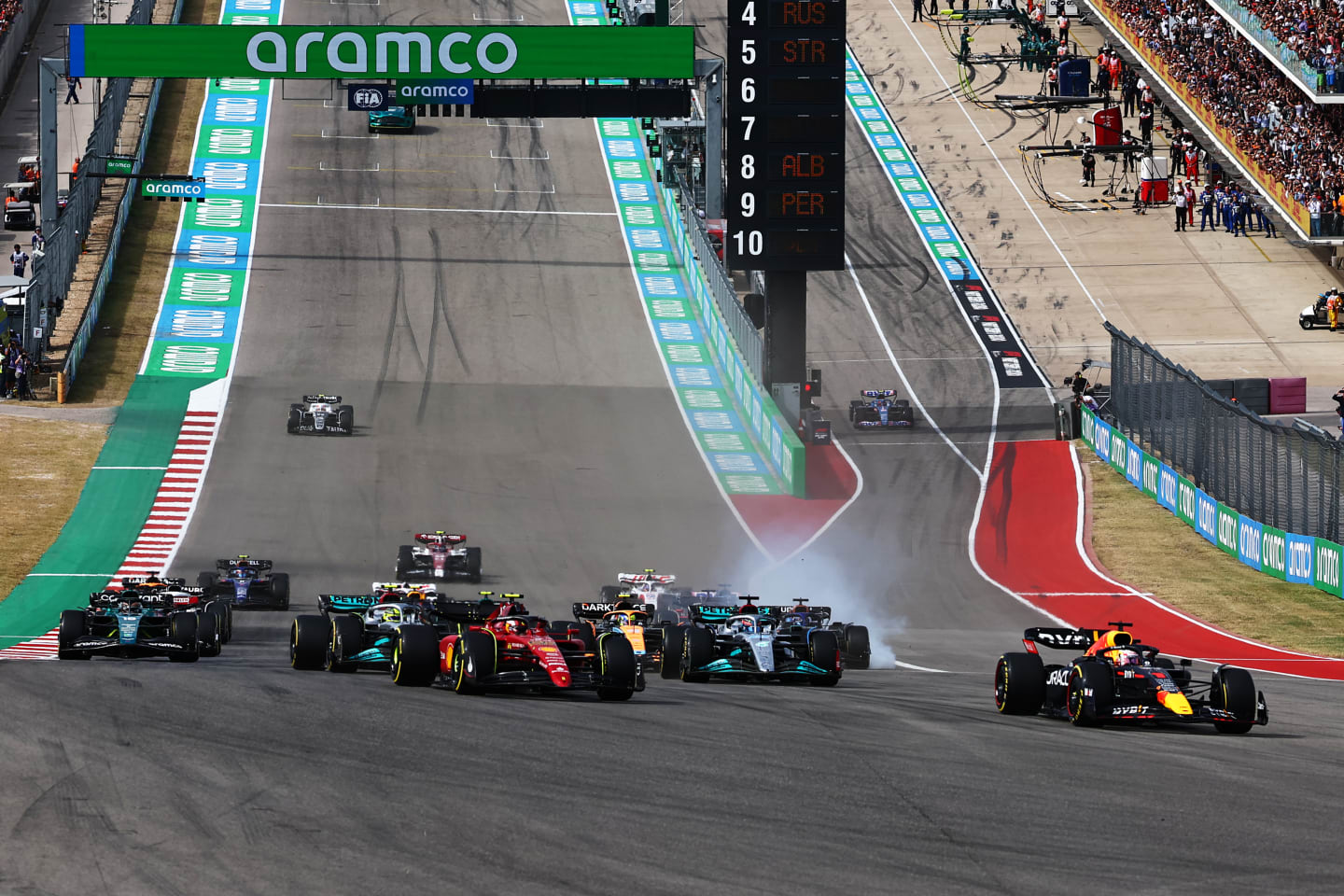 AUSTIN, TEXAS - OCTOBER 23: Max Verstappen of the Netherlands driving the (1) Oracle Red Bull Racing RB18 leads Carlos Sainz of Spain driving (55) the Ferrari F1-75 and the rest of the field at the start during the F1 Grand Prix of USA at Circuit of The Americas on October 23, 2022 in Austin, Texas. (Photo by Mark Thompson/Getty Images)