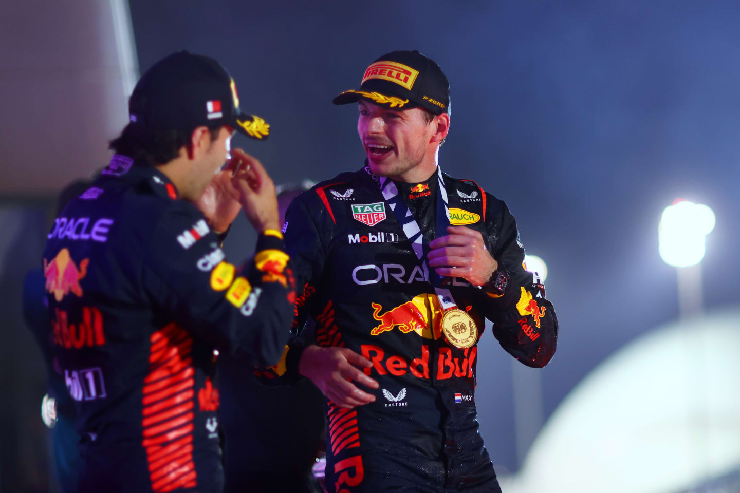 BAHRAIN, BAHRAIN - MARCH 05: Race winner Max Verstappen of the Netherlands and Oracle Red Bull Racing celebrates with team-mate Second placed Sergio Perez of Mexico and Oracle Red Bull Racing on the podium during the F1 Grand Prix of Bahrain at Bahrain International Circuit on March 05, 2023 in Bahrain, Bahrain. (Photo by Dan Istitene - Formula 1/Formula 1 via Getty Images)