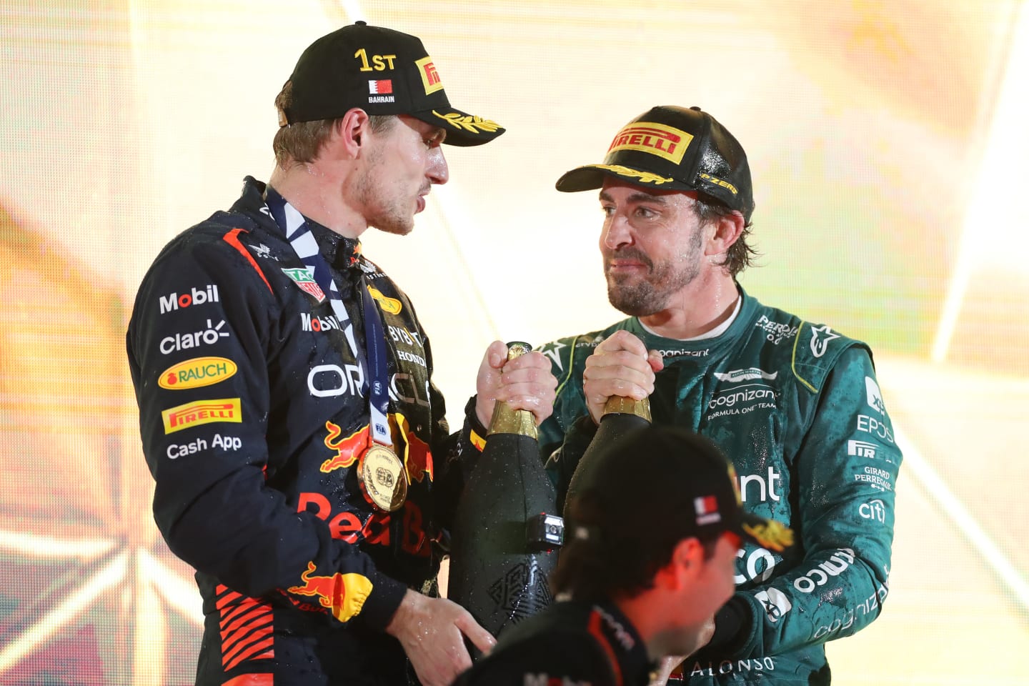 BAHRAIN, BAHRAIN - MARCH 05: Race winner Max Verstappen of the Netherlands and Oracle Red Bull Racing and Third placed Fernando Alonso of Spain and Aston Martin F1 Team celebrate on the podium during the F1 Grand Prix of Bahrain at Bahrain International Circuit on March 05, 2023 in Bahrain, Bahrain. (Photo by Peter Fox/Getty Images)